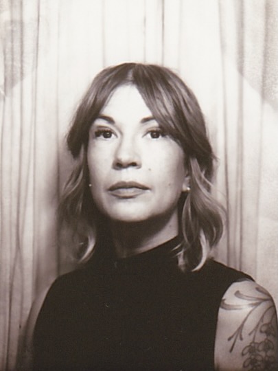 Black and White photo of the collector,
							Katherine, in a photobooth
